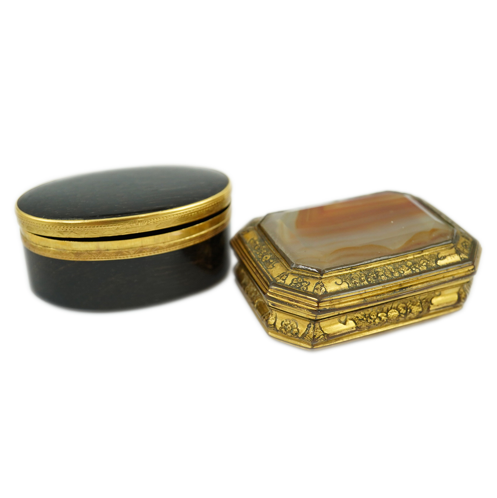 An early 19th century German gold mounted rutile agate? oval snuff box, 64mm and another gilt copper mounted agate snuff box.